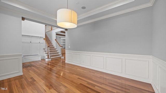 1019 Falkirk Dr, Burlington, NC 27215 - unfurnished room with a decorative wall, ornamental molding, stairs, wood finished floors, and wainscoting