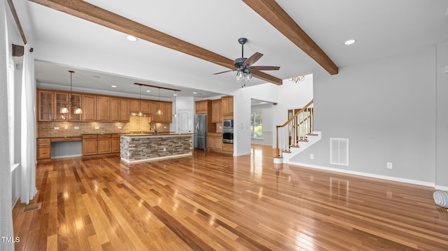 1019 Falkirk Dr, Burlington, NC 27215 - unfurnished living room with light wood-type flooring, a ceiling fan, beamed ceiling, stairway, and recessed lighting