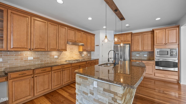 1019 Falkirk Dr, Burlington, NC 27215 - kitchen featuring brown cabinetry, stainless steel appliances, and recessed lighting