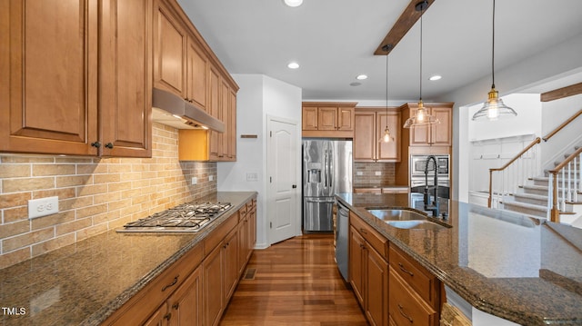 1019 Falkirk Dr, Burlington, NC 27215 - kitchen with dark stone countertops, brown cabinets, wood finished floors, decorative light fixtures, and recessed lighting