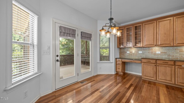 1019 Falkirk Dr, Burlington, NC 27215 - kitchen with built in study area, brown cabinetry, and dark wood finished floors