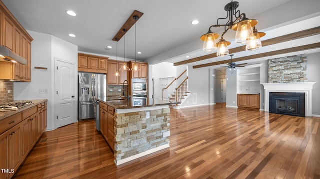 1019 Falkirk Dr, Burlington, NC 27215 - kitchen with a ceiling fan, decorative backsplash, wood finished floors, appliances with stainless steel finishes, and recessed lighting