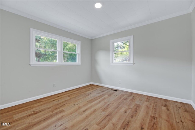 1109 Magnolia Dr, Durham, NC 27707 - spare room featuring ornamental molding, plenty of natural light, and wood finished floors
