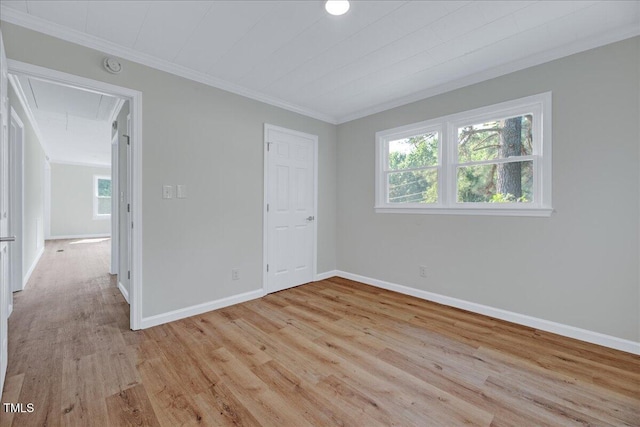 1109 Magnolia Dr, Durham, NC 27707 - unfurnished bedroom with attic access, crown molding, light wood-style floors, and multiple windows