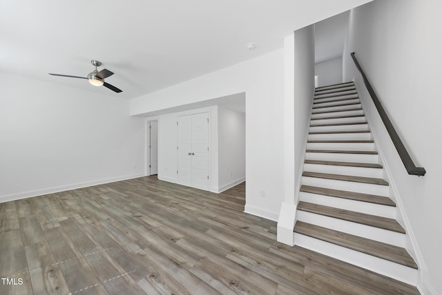506 Village Branch Ln, Wake Forest, NC 27587 - unfurnished living room with stairway, ceiling fan, and wood finished floors