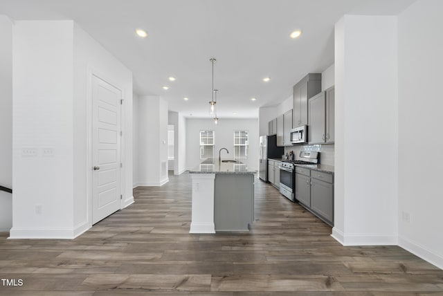 506 Village Branch Ln, Wake Forest, NC 27587 - kitchen featuring stainless steel appliances, gray cabinetry, dark wood-style flooring, recessed lighting, and an island with sink