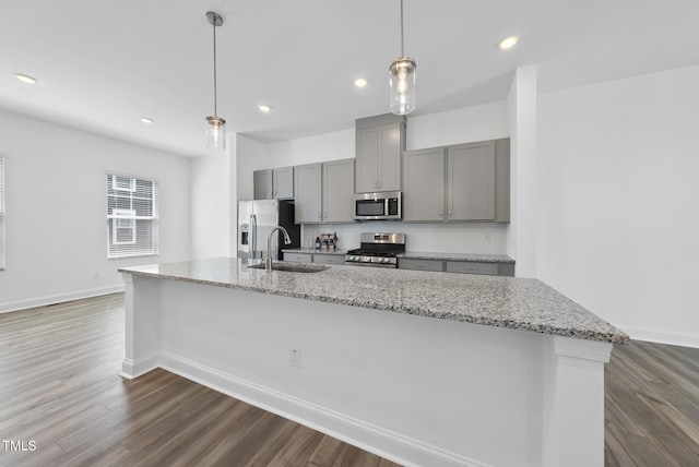 506 Village Branch Ln, Wake Forest, NC 27587 - kitchen featuring stainless steel appliances, gray cabinets, a spacious island, dark wood finished floors, and light stone counters