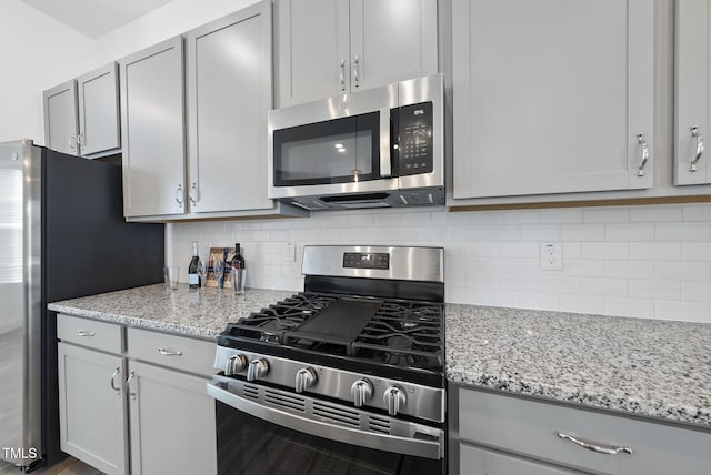 506 Village Branch Ln, Wake Forest, NC 27587 - kitchen with appliances with stainless steel finishes, decorative backsplash, gray cabinets, and light stone countertops