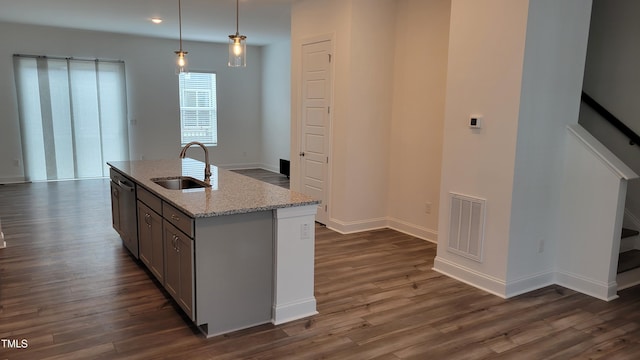 506 Village Branch Ln, Wake Forest, NC 27587 - kitchen with dark wood-type flooring, light stone countertops, decorative light fixtures, and stainless steel dishwasher