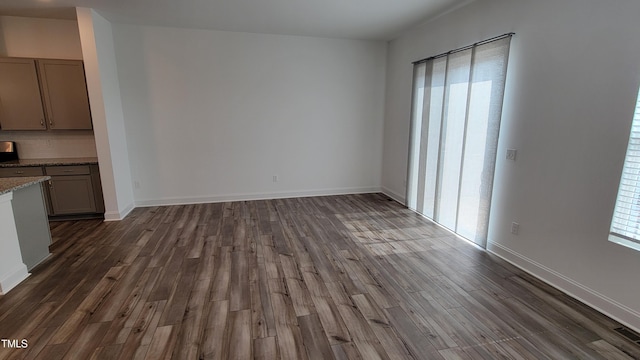 506 Village Branch Ln, Wake Forest, NC 27587 - unfurnished living room with dark wood finished floors and baseboards