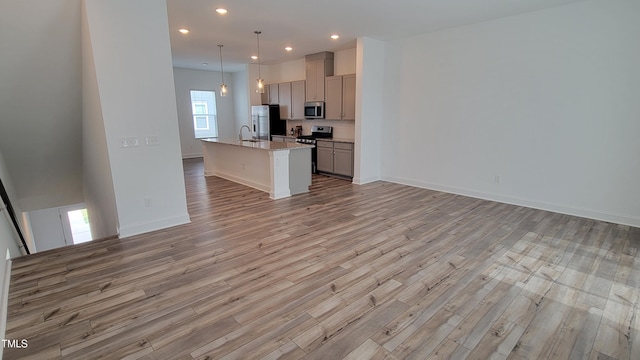 506 Village Branch Ln, Wake Forest, NC 27587 - kitchen with appliances with stainless steel finishes, gray cabinets, open floor plan, light wood-style flooring, and recessed lighting