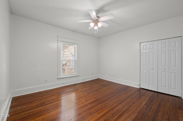 1309 Watts St, Durham, NC 27701 - unfurnished bedroom with dark wood finished floors, a closet, and a ceiling fan