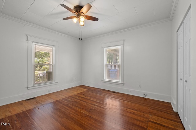 1309 Watts St, Durham, NC 27701 - unfurnished bedroom with hardwood / wood-style flooring, a closet, crown molding, and ceiling fan