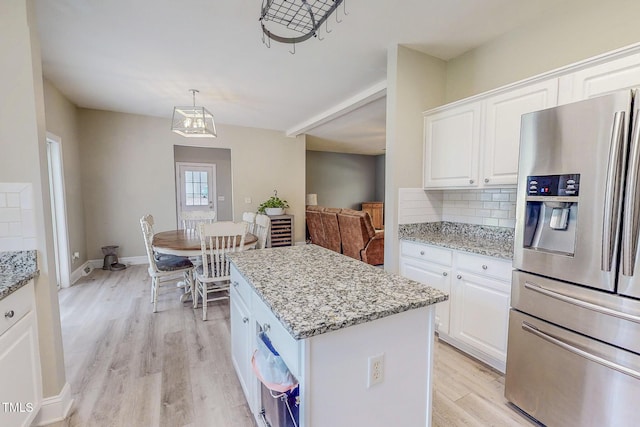 125 Al Gray Rd, Timberlake, NC 27583 - kitchen with stainless steel fridge with ice dispenser, light wood-type flooring, a kitchen island, and decorative backsplash