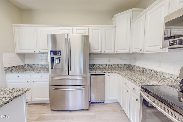 125 Al Gray Rd, Timberlake, NC 27583 - kitchen with stainless steel appliances, decorative backsplash, and white cabinetry