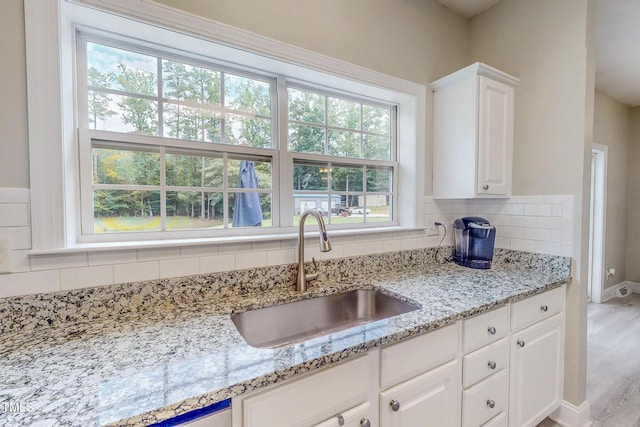 125 Al Gray Rd, Timberlake, NC 27583 - kitchen featuring backsplash, white cabinetry, and light stone countertops