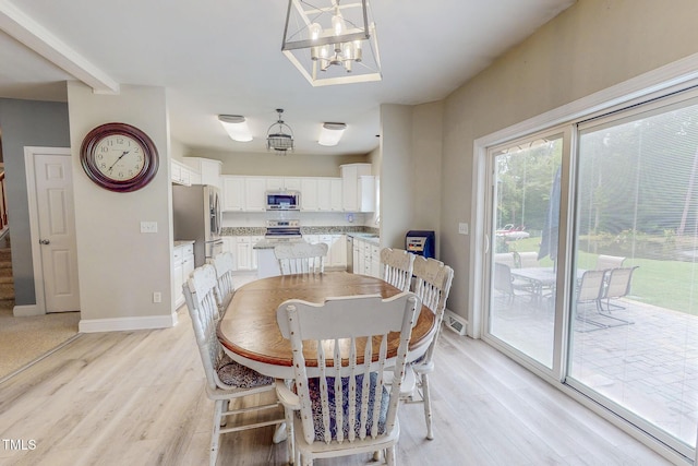 125 Al Gray Rd, Timberlake, NC 27583 - dining space with light wood-style floors, a chandelier, and stairway