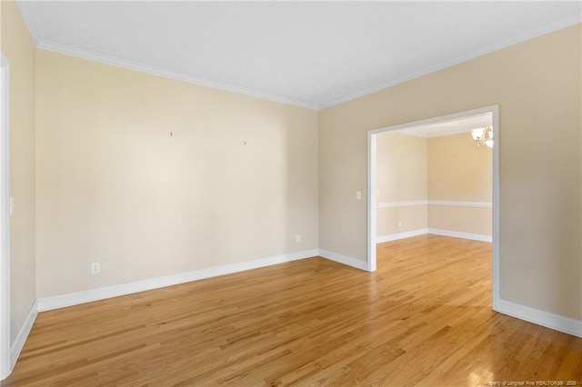 8017 Trout Creek Rd, Fayetteville, NC 28304 - spare room with ornamental molding, light wood-style flooring, and a chandelier