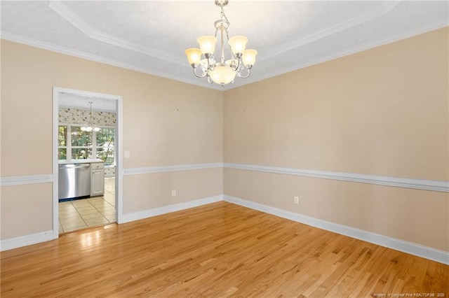 8017 Trout Creek Rd, Fayetteville, NC 28304 - empty room with a chandelier, light wood-type flooring, crown molding, and a tray ceiling
