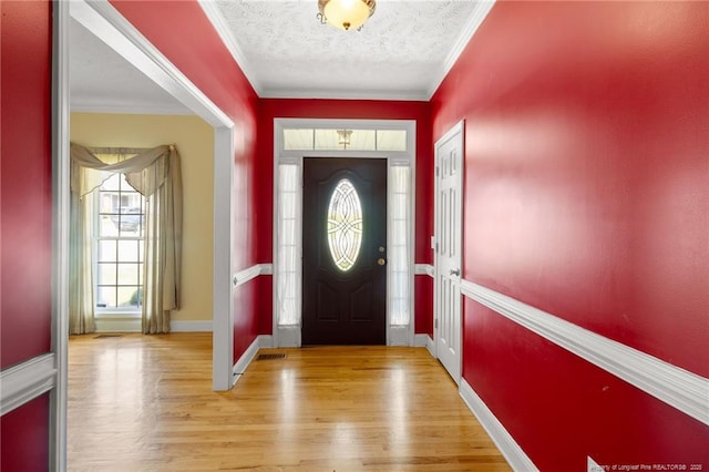 8017 Trout Creek Rd, Fayetteville, NC 28304 - entryway with wood finished floors, a textured ceiling, and ornamental molding