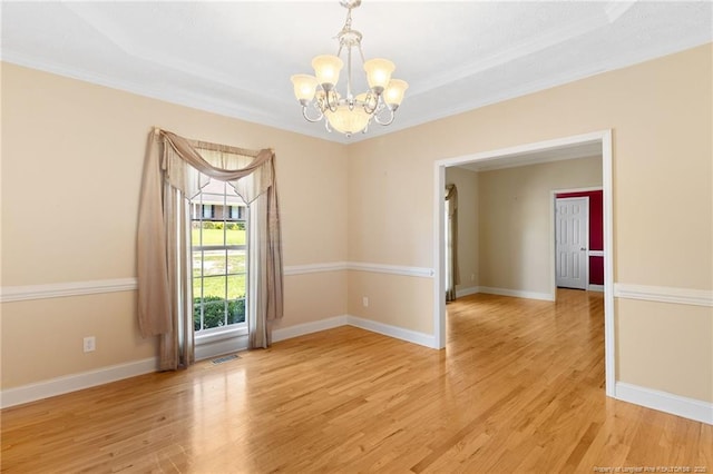 8017 Trout Creek Rd, Fayetteville, NC 28304 - empty room with a chandelier, ornamental molding, light wood-style flooring, and a raised ceiling