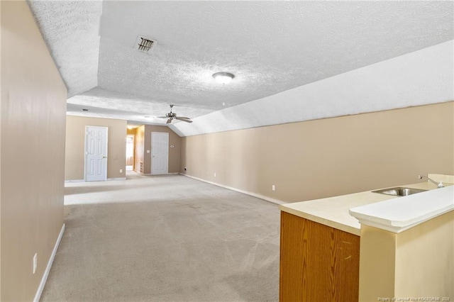 8017 Trout Creek Rd, Fayetteville, NC 28304 - unfurnished living room with lofted ceiling, a ceiling fan, a textured ceiling, and light colored carpet
