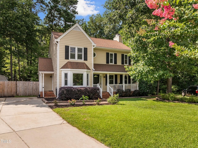 103 Wyseferry Ct, Morrisville, NC 27560 - view of front of home with a porch, a chimney, roof with shingles, and driveway