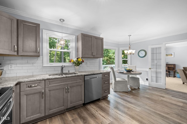 103 Wyseferry Ct, Morrisville, NC 27560 - kitchen with stainless steel appliances, light wood-type flooring, a chandelier, tasteful backsplash, and ornamental molding