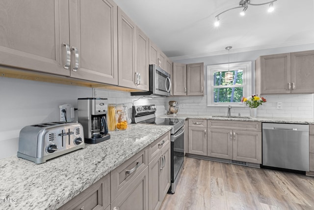 103 Wyseferry Ct, Morrisville, NC 27560 - kitchen with stainless steel appliances, light wood-type flooring, tasteful backsplash, light stone counters, and crown molding