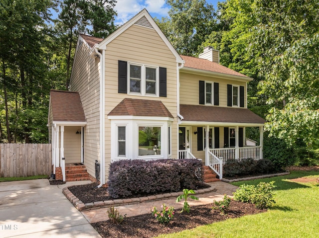 103 Wyseferry Ct, Morrisville, NC 27560 - traditional-style house with a chimney, covered porch, and a shingled roof