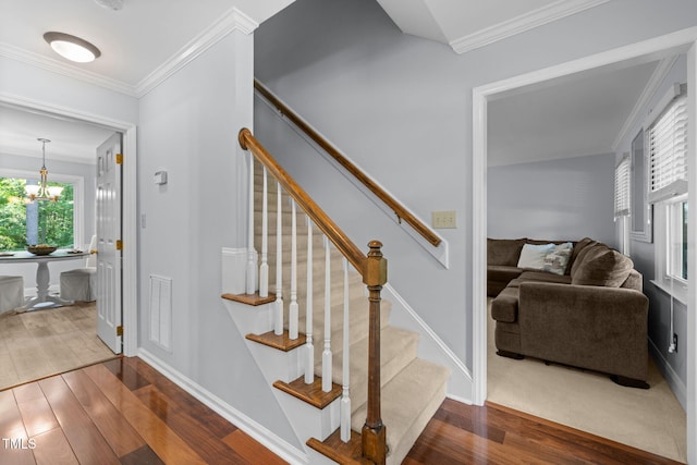 103 Wyseferry Ct, Morrisville, NC 27560 - stairs featuring wood finished floors, crown molding, and a chandelier