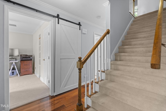 103 Wyseferry Ct, Morrisville, NC 27560 - staircase featuring a barn door, wood finished floors, and ornamental molding