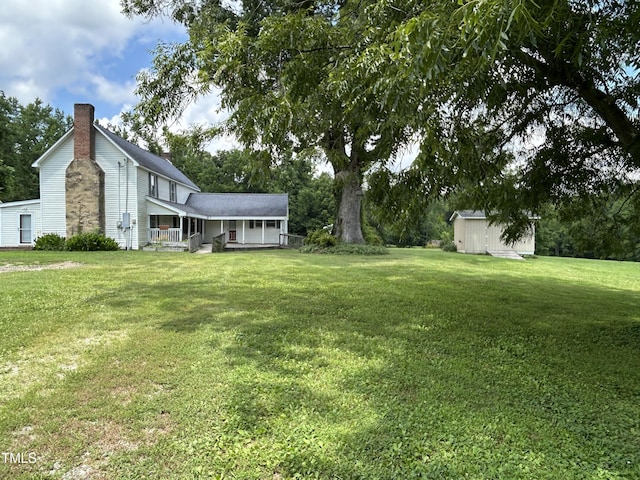 243 Victor Chandler Rd, Timberlake, NC 27583 - view of grassy yard featuring covered porch and a storage shed