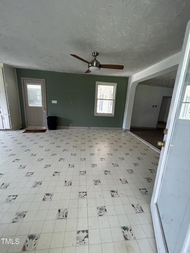 243 Victor Chandler Rd, Timberlake, NC 27583 - unfurnished living room featuring ceiling fan, plenty of natural light, and a textured ceiling