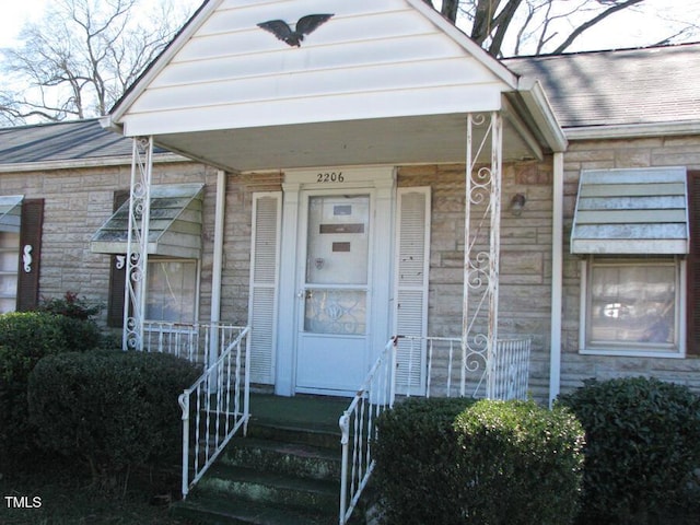2206 E Club Blvd, Durham, NC 27704 - doorway to property featuring stone siding and roof with shingles