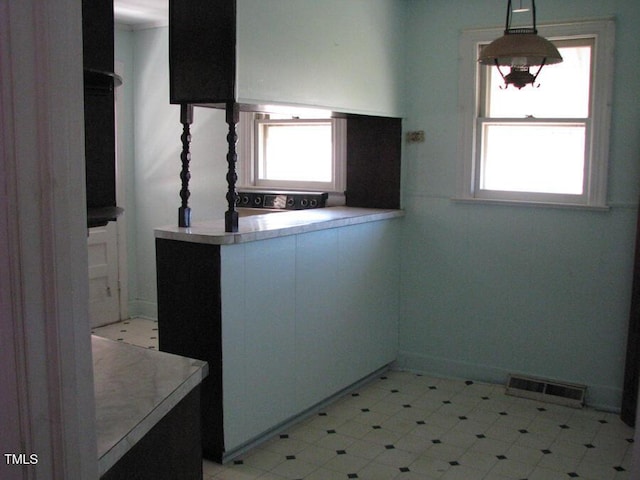 2206 E Club Blvd, Durham, NC 27704 - kitchen with plenty of natural light, pendant lighting, and white cabinets