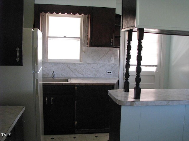 2206 E Club Blvd, Durham, NC 27704 - kitchen with freestanding refrigerator, light countertops, and decorative backsplash