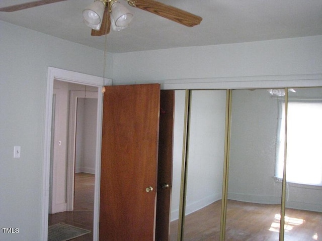 2206 E Club Blvd, Durham, NC 27704 - unfurnished bedroom with a closet, wood finished floors, and a ceiling fan