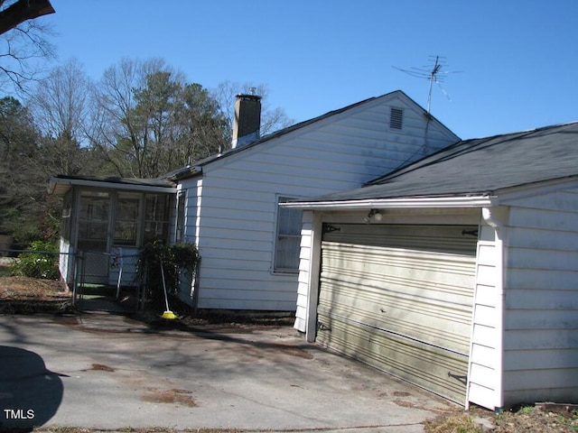 2206 E Club Blvd, Durham, NC 27704 - view of home's exterior featuring a chimney and a sunroom