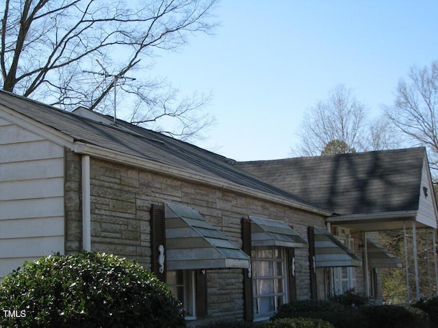 2206 E Club Blvd, Durham, NC 27704 - exterior view of a downspout, stone siding, and gutters