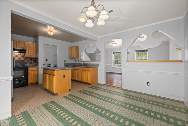 5528 Wilhagan Ct, Raleigh, NC 27616 - kitchen with electric range, a chandelier, under cabinet range hood, a center island, and backsplash