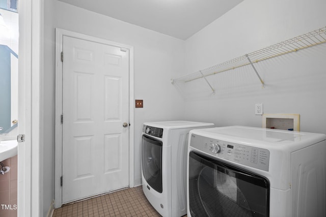 5528 Wilhagan Ct, Raleigh, NC 27616 - laundry area featuring independent washer and dryer and light tile patterned flooring
