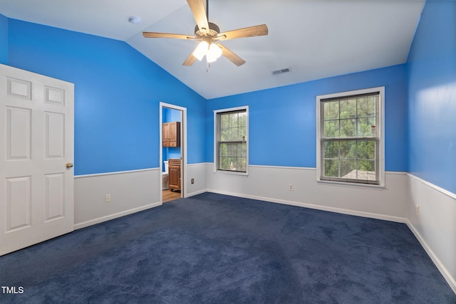 5528 Wilhagan Ct, Raleigh, NC 27616 - unfurnished bedroom featuring dark carpet, lofted ceiling, ensuite bath, and a ceiling fan
