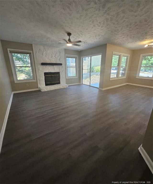 6771 Willowbrook Dr Unit 6, Fayetteville, NC 28314 - unfurnished living room featuring a textured ceiling, a ceiling fan, a fireplace, and dark wood finished floors