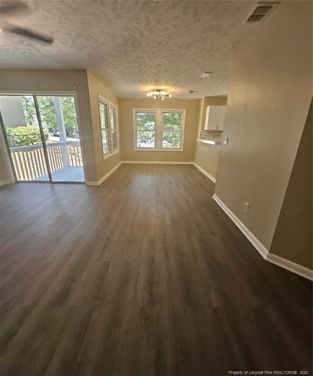 6771 Willowbrook Dr Unit 6, Fayetteville, NC 28314 - unfurnished living room with dark wood-style flooring and a textured ceiling