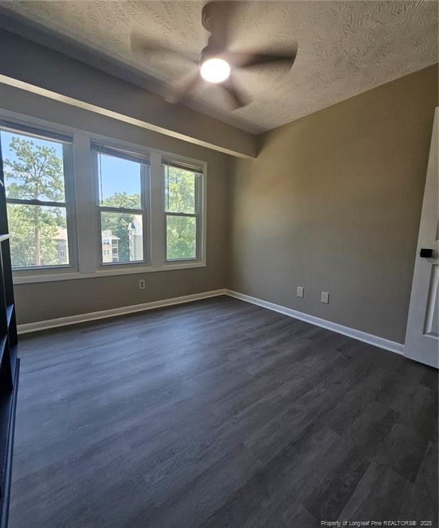 6771 Willowbrook Dr Unit 6, Fayetteville, NC 28314 - spare room featuring a textured ceiling, ceiling fan, and dark wood-style flooring
