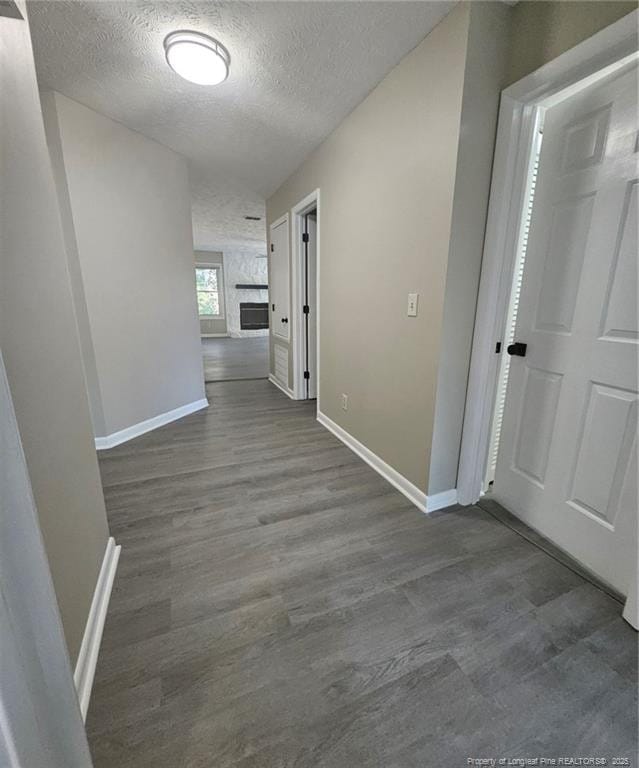 6771 Willowbrook Dr Unit 6, Fayetteville, NC 28314 - hallway with a textured ceiling and dark wood-style floors
