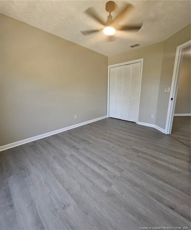 6771 Willowbrook Dr Unit 6, Fayetteville, NC 28314 - unfurnished bedroom with dark wood finished floors, a closet, a ceiling fan, and a textured ceiling