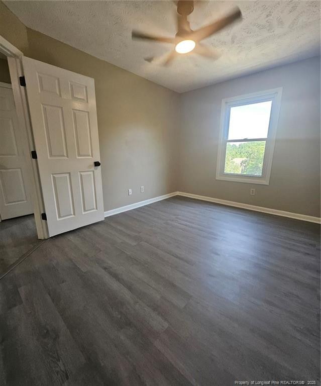 6771 Willowbrook Dr Unit 6, Fayetteville, NC 28314 - spare room featuring ceiling fan, dark wood-type flooring, and a textured ceiling