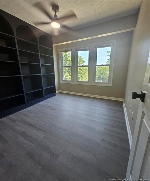 6771 Willowbrook Dr Unit 6, Fayetteville, NC 28314 - unfurnished room featuring dark wood-style flooring, a textured ceiling, and ceiling fan